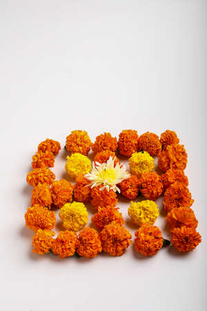 Marigold Flower rangoli Design with oil lamps for Diwali Festival.