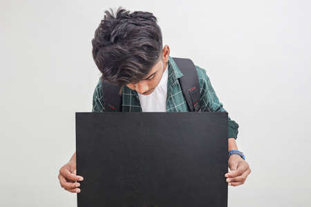 Young Indian college boy Showing Direction With Handの写真素材