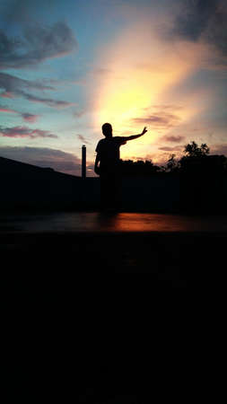 A girl in Beautiful cloud landscape with silhouette tree evening