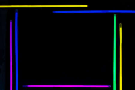 Dark background with neon sticks forming a rectangle with light