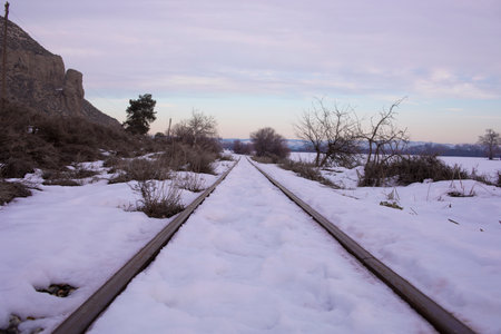 Snowy landscape on a train trackの写真素材