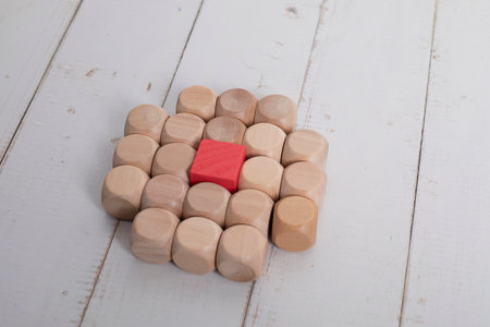Upper view of square pieces of wood with a red square