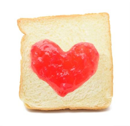 Jam heart drawn on a piece of bread.の写真素材