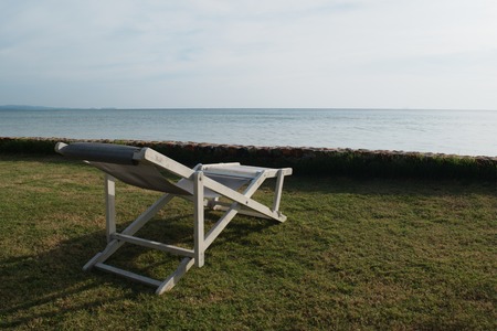 White chairs for sunbathing on the beach.