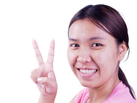 Women who are happy to sit and show two fingers.の写真素材
