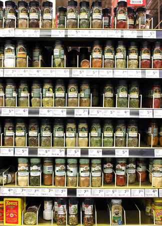 Various spices and seasoning powders on shelves in a supermarketのeditorial素材