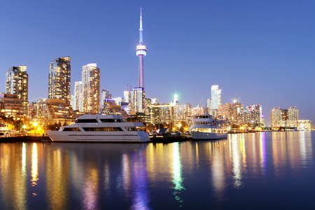 Toronto skyline at dusk over lake with colorful reflectionsの写真素材