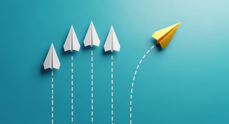 A single yellow paper airplane breaks away from a group of white planes, symbolizing individuality and innovation.の素材