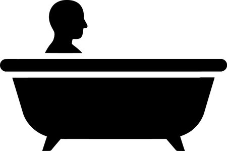 A minimalist black silhouette depicts a person's head and shoulders visible above a classic clawfoot bathtub.のイラスト素材