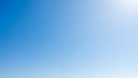 Experience the serenity of a vibrant blue sky with bright sunlight shining through, evoking feelings of peace and tranquility.の素材