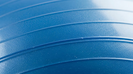 Detailed view of a blue ridged surface with water droplets, showcasing texture and industrial designの素材