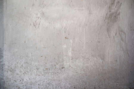 dirty smooth concrete wall background texture with stains and copy spaceの写真素材
