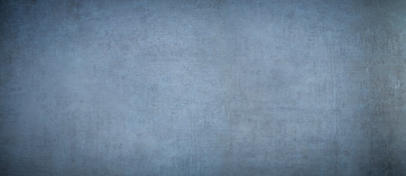 scratched and stained concrete wall background with blue tintの写真素材