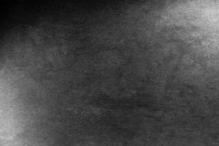 rough black stone background texture grunge concrete wall with light spotsの写真素材