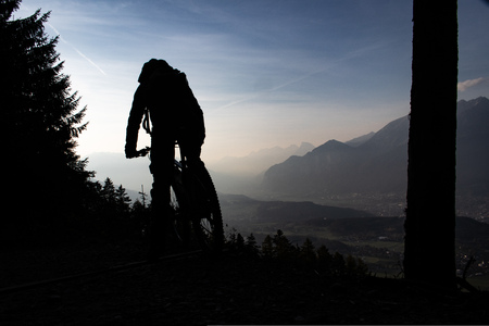 Silhouette of a mountain biker in the european Alps at the Patscherkofel mountain near Innsbruck, Tyrol, Austriaの写真素材