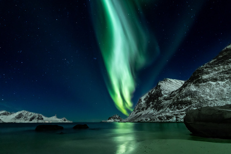 Beautiful green Northern Lights at Haukland Beach on the Lofoten Islands in Norwayの写真素材
