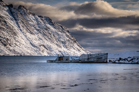 Shipwreck in a fjord on the Lofoten Islands in Norway in winterの写真素材