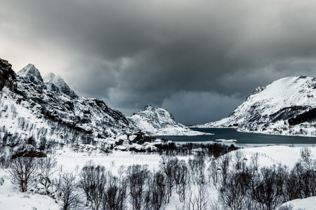 Tangstadfjord on the Lofoten Islands in Norway in winter with dramatic cloudsの写真素材