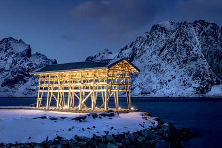 Wood Rack for stockfish near Sakrisoy on the Lofoten Islands in Norway at winter and at nightの写真素材