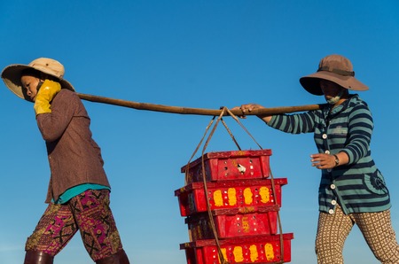 Duy Hai, Vietnam - August 15, 2015: women bringing in the night's catch in Duy Hai, a fishing village across the Thu Bon River from Hoi An.のeditorial素材
