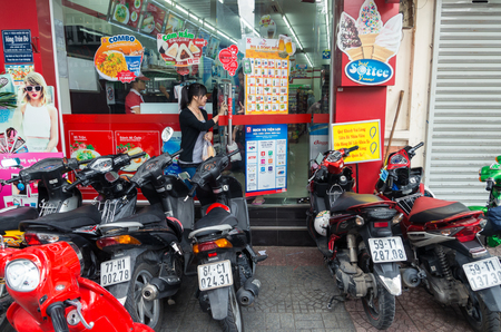 Ho Chi Minh City, Vietnam - August 20, 2015: motor scooters parked outside a convenience store in central Ho Chi Minh City. Motor scooters are common transportation in Vietnam.のeditorial素材