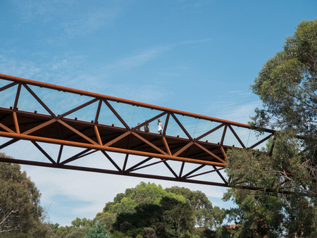 Melbourne, Australia - January 26, 2018: elevated walkway crossing Gardiners Creek connecting two...