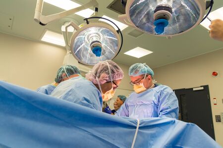 Melbourne, Australia - June 7, 2019: surgeons performing a caesarean section in an operating theatre in the Royal Women's Hospital.のeditorial素材