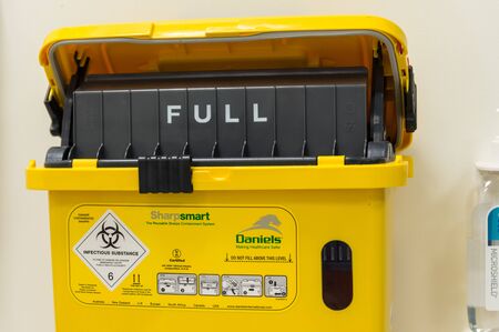 Melbourne, Australia - June 7, 2019: Daniels Sharpsmart sharps disposal unit in the Royal Women's Hospital. Sharps disposal units are used to dispose of used syringes.のeditorial素材