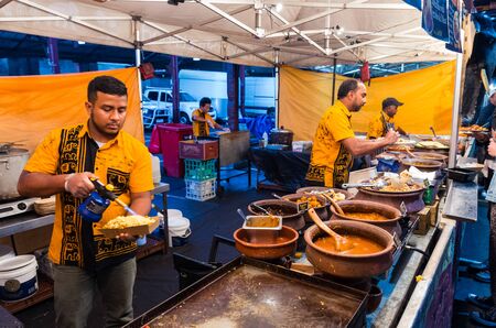 Melbourne, Australia - March 6, 2019: a man preparing Sri Lankan street food at the Queen Victoria Market night market. The night market operates annually, once a week.のeditorial素材