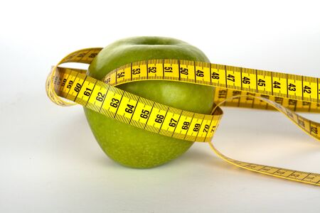 fresh green apple with yellow measure tape の写真素材