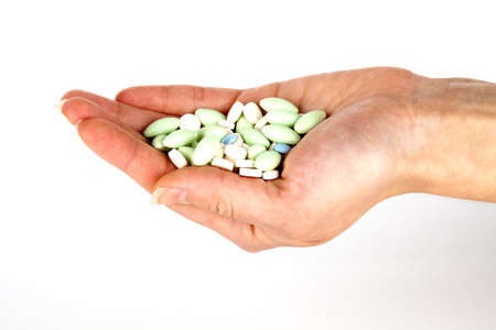 left hand with pills for healthcareの写真素材