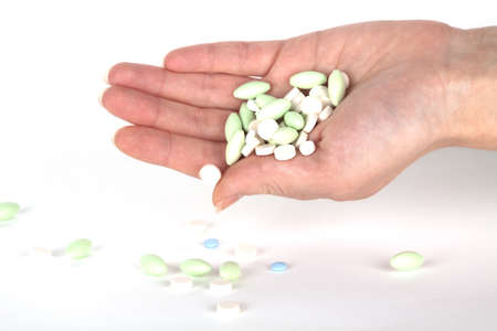 left hand with pills for healthcareの写真素材
