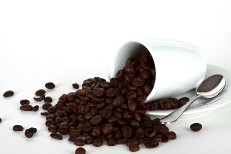 white coffe cup with coffe beans and a silver spoonの写真素材