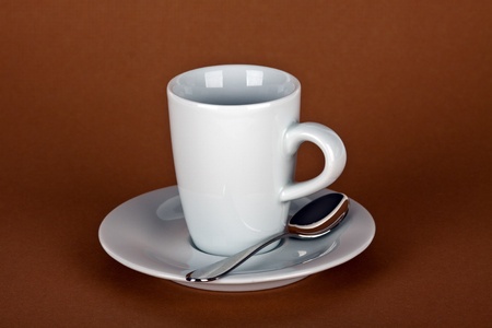white coffe cup with coffe beans and a silver spoonの写真素材