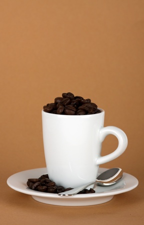 white coffe cup with coffe beans and a silver spoonの写真素材