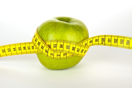 fresh green apple with yellow measure tape の写真素材