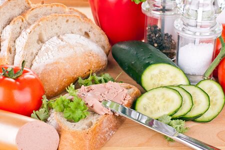breakfast or lunch with mixed vegetables, sausage and a knifeの写真素材