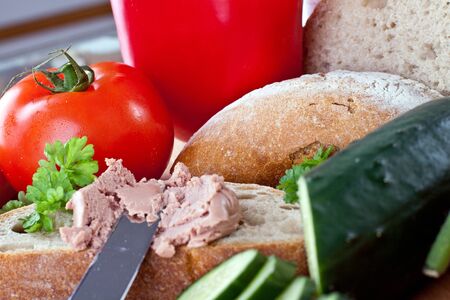 breakfast or lunch with mixed vegetables, sausage and a knifeの写真素材