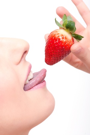 close-up woman´s lips and a strawberryの写真素材
