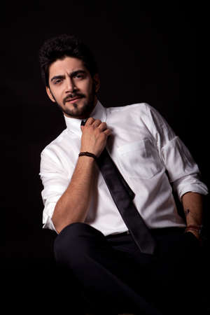 young successful business man with a suit isolated on black backgroundの写真素材