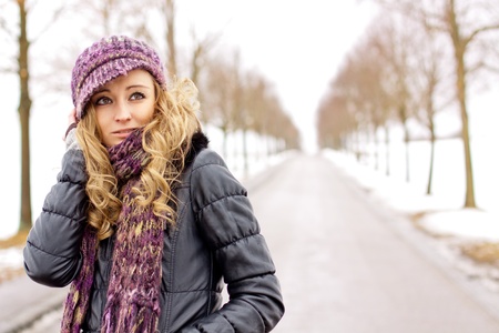 young woman outside in winter in snow coldの写真素材