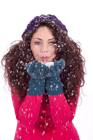 beautiful smiling brunette woman in snow in winter  isolated on white backgroundの写真素材
