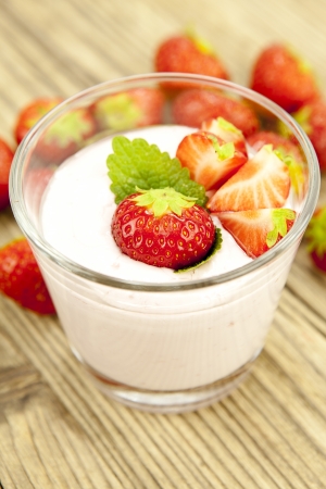 fresh tasty strawberry yoghurt shake dessert on wooden backgroundの写真素材