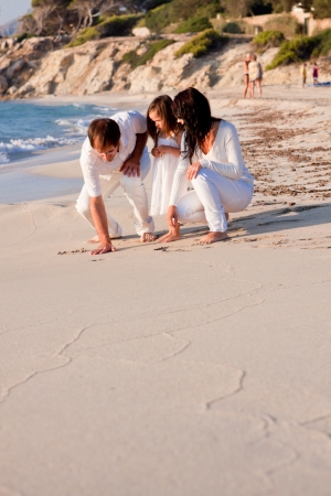 happy young family with daughter on beach in summer lifestyleの写真素材