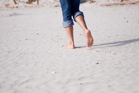 barefoot in sand and water on beach  in summer holidays relaxingの写真素材