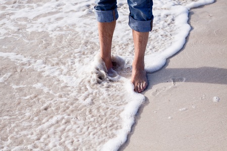 barefoot in sand and water on beach  in summer holidays relaxingの写真素材