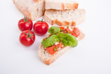 deliscious fresh bruschetta appetizer with tomatoes isolated on white backgroundの写真素材