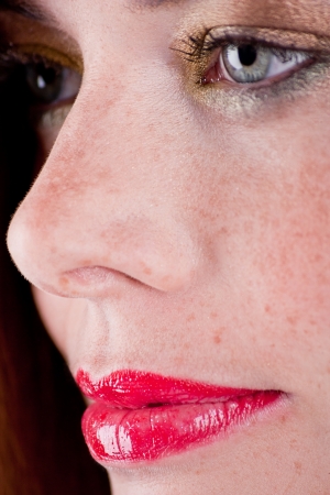 beautiful young woman portrait with freckles profile close upの写真素材