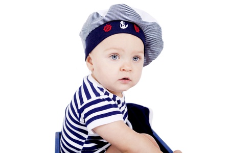 cute little baby in sailor fashion playing isolated on white backgroundの写真素材