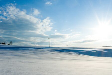 beautiful sunny landscape in winter with blue sky and snowの写真素材